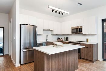 Chef-inspired kitchen with custom backsplash and designer stainless steel appliances